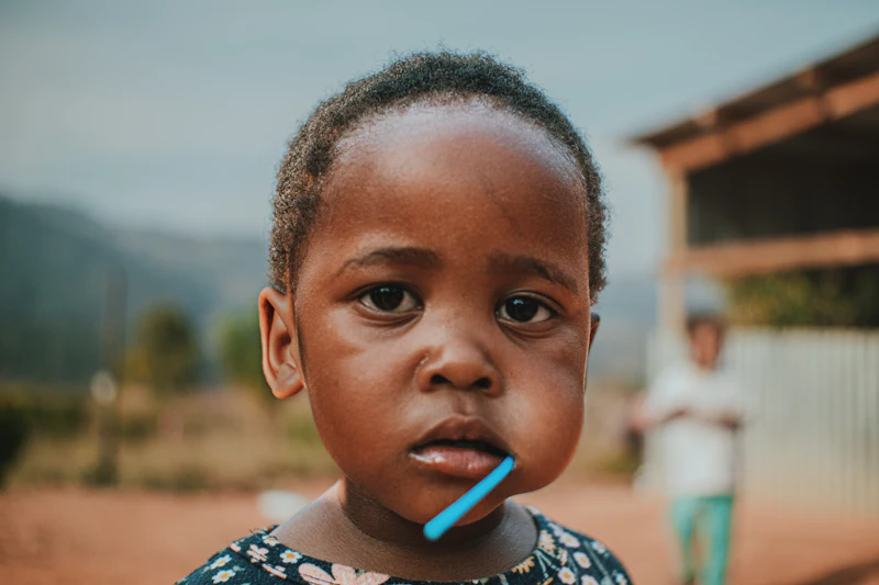 A young child with a toothbrush in his mouth