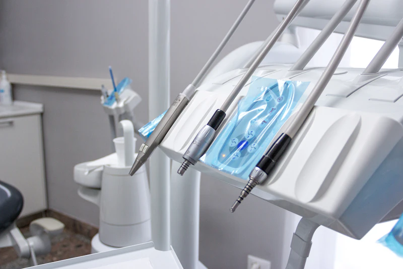 Dental drills resting in their holders on a bright dental chair unit